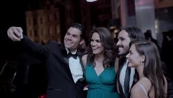 Glamorous Hollywood couples pose for smartphone selfie on red carpet at awards show Stock Footage