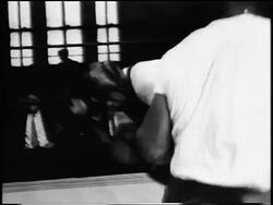 B/W 1956 Archie Moore boxing other man in training in gym / newsreel Stock Footage