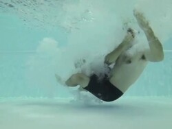 Man jumping and diving in swimming pool - slow motion Stock Footage