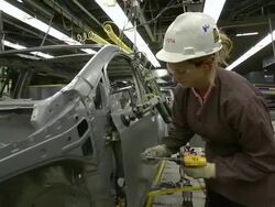 MS PAN TU TD Woman installing an unpainted door on mini van / Princeton, Indiana, United States Stock Footage