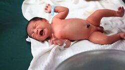 Footage of the one-day-old newborn baby showers Stock Footage