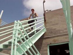 A man does a parkour freerunning jump down stairs. - Slow Motion - Model Released - 1920x1080 - HD Stock Footage