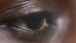 ECU African-American person closing brown eye Stock Footage
