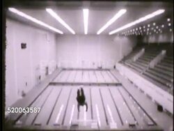 1963: UNITED STATES AIR FORCE ACADEMY: VS Cadets in boxing gear (helmet, gloves) boxing in gym, another diving off high platform dive board into pool, cadet pole vaulting, two playing squash (racquet sport), one kicking soccer ball around flag course. Instructional Video