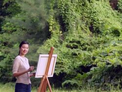 WS artist painting on her easel in a forest. Stock Footage