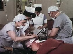Nurses prepare IV line for patient Stock Footage