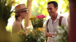 Cute couple in Brazilian marketplace smell colorful flowers and laugh together Stock Footage