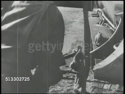 1942: UNITED STATES WAR EFFORT IN MELANESIA: VS U.S. workers assembling wing to fighter aircraft fuselage, attaching tail rudder, machine gun turrets, & engine propeller. World War II, WWII, war production, assembly, Pacific Front Instructional Video