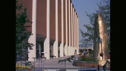 WS ZO People walking outside modern building with fountain in foreground / United States Stock Footage