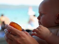 Cute little baby eating sweet juicy peach Stock Footage