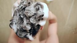 Young woman washing her hair. Stock Footage