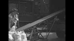 Employees at US Mint in Philadelphia load bags of coins onto trucks News Clip