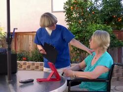 Health care worker on patio with two people Stock Footage