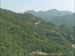 Pan left over Great Wall of China, busy with tourists, Badaling, China Stock Footage