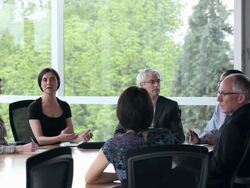 MS PAN coworkers in discussion in conference room/Seattle, Washington, USA Stock Footage