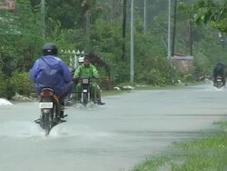 Motorbike driving through flood waters 60km NE of Laoag, Philippines, typhoon Parma 4th October 2009 Stock Footage