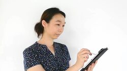 Asian woman using tablet-pc on white background Stock Footage