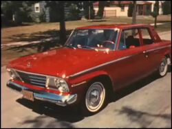 1964 Studebaker Commander drving through suburb Stock Footage