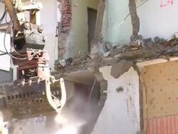 MS Demolition of apartment block and man watering / Saarburg, Rhineland-Palatinate, Germany Stock Footage