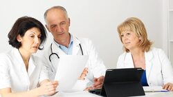 Doctors team looking at  document Stock Footage