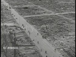 1945: HIROSHIMA, JAPAN: XHA TD WS People riding bicycles, walking on road lined w/ flat rubble landscape. WS block w/ partial building standing. WS Leaning building w/ telephone pole standing BG.  Nuclear weapon, end of WWII. Instructional Video