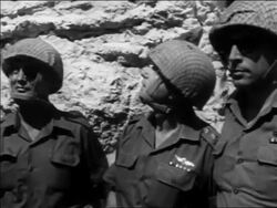 B/W 1967 tilt up 3 soldiers (one is Moshe Dayan) looking up at Wailing Wall after Six Day War / Jerusalem Stock Footage