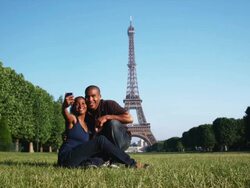 couple taking their own photo in front of the Eiffel tower Stock Footage