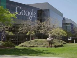 MS PAN Woman on grass using laptop in front of headquarter's campus with building and logo / Mountain View, California, United States Stock Footage