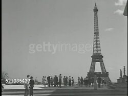 MOT 1947: PARIS, FRANCE: FRENCH FASHION: Angled WS La Tour Eiffel (Eiffel Tower) on Champs de Mars w/ people standing FG. Angled WS Champs-Elysees & traffic w/ Arc de Triomphe BG, WS Customers & waiters in outdoor cafe w/ city traffic & Arc de Triomphe Instructional Video