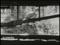 1941: SWEDEN TROOP TRAIN DEAL: Soldier checking under train, Nazi German soldiers watching from window, train begins to move.  WWII, Active neutrality. Instructional Video