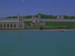 AERIAL WS ZI Flying over water toward R.C. Harris Filtration Plant / Toronto, Canada Stock Footage