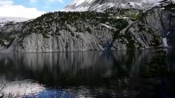 Snowmass Lake Aspen Wilderness Area with Huge Rock Cliffs and amazing Reflection of Alpine Tundra and High Altitude Peaks in Rocky Mountains Stock Footage