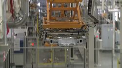 An automated lift transports car parts across a factory. Stock Footage