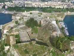 WS AERIAL View of Kerkyra island (Corfu city) with small boats, buildings and car parking area / Corfu, Ionian Islands, Greece Stock Footage