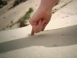 CU Girl drawing on sand / Cape Kiwanda, Oregon, USA Stock Footage