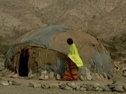 Woman fixing straw on hut Stock Footage