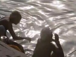 MS Rear view of men bathing in Ganges river / Varanasi, India Stock Footage
