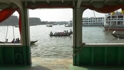 Sadarghat Launch Terminal in Dhaka Bangladesh is a bustling passenger transport hub where tiny wooden boat taxis paddle alongside huge steel ferries Stock Footage