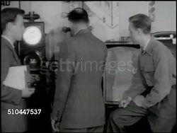 1949: YALE UNIVERSITY TRAFFIC LIGHTS: WS Instructor & students talking, studying traffic lights in classroom. MS Young male student w/ stop watch, timer, timing traffic light. CU Rotating clock inside of traffic light, stop watch FG. Instructional Video