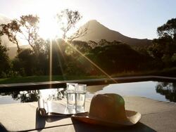 Swimming pool looking out to scenic mountain sunset Stock Footage