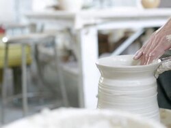 Midsection of man throwing clay on potters wheel Stock Footage