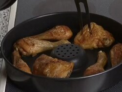 Chicken legs being backed in pan Stock Footage