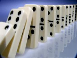High Speed Dominoes - MCU side angled view, row of dominoes fall over away from camera Stock Footage