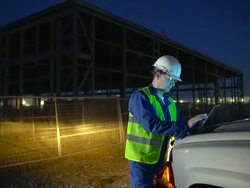 Engineer or job superintendent uses a tablet on construction site Stock Footage