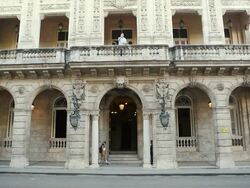 MS Shot of Majestic old building with Traffic and Pedestrians / Havana, Cuba  Stock Footage