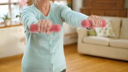 SLO MO senior woman doing hand weights exercises at home Stock Footage