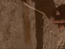 Close Up, tilt-up - A scientist applies a solution to a stone wall at an archaeological excavation site / Egypt Stock Footage
