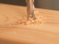 CU Drill bit coming down straight into wood / Los Angeles, California, United States Stock Footage