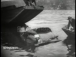 1935: BELGIUM TRAGEDY:  MS Queen of Belgium Astrid (1905-1935) & King Leopold III greeting man. VS Boats fishing wrecked car out of water. WS Queen Astrid funeral procession, Belgian mourners. HA MS King Leopold III walking w/ bandage & arm cast. Instructional Video