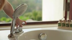 Woman Turning on a Shower in Bathroom Stock Footage